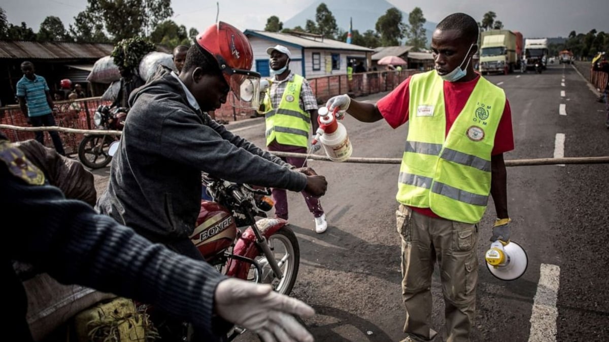 A driver gets his hands washed at an Ebola screening station