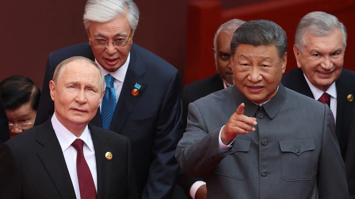 Russian President Vladimir Putin, left, speaks with Chinese President Xi Jinping in Beijing